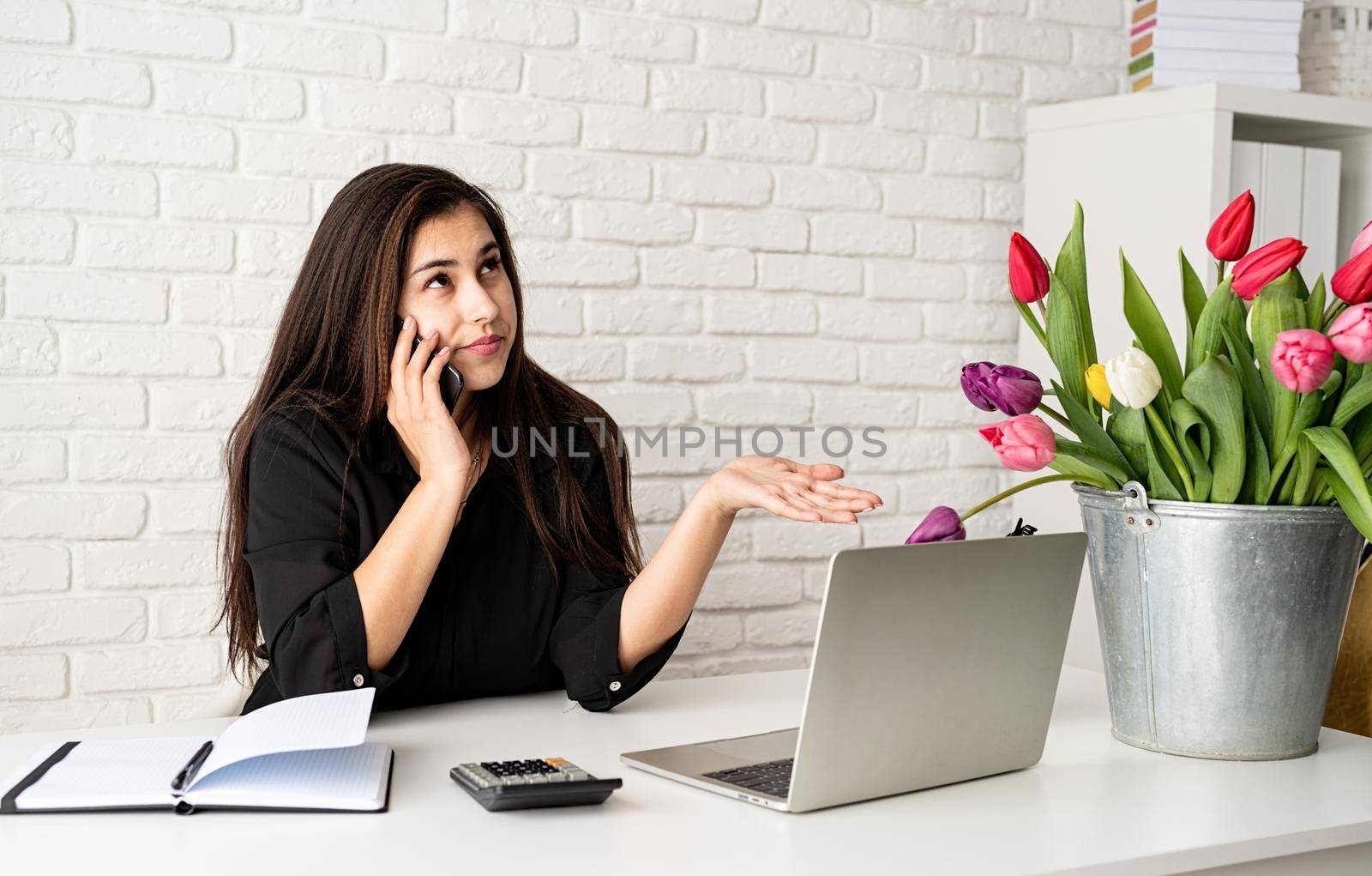 young brunette business woman florist Talking on the phone, working at the office by Desperada