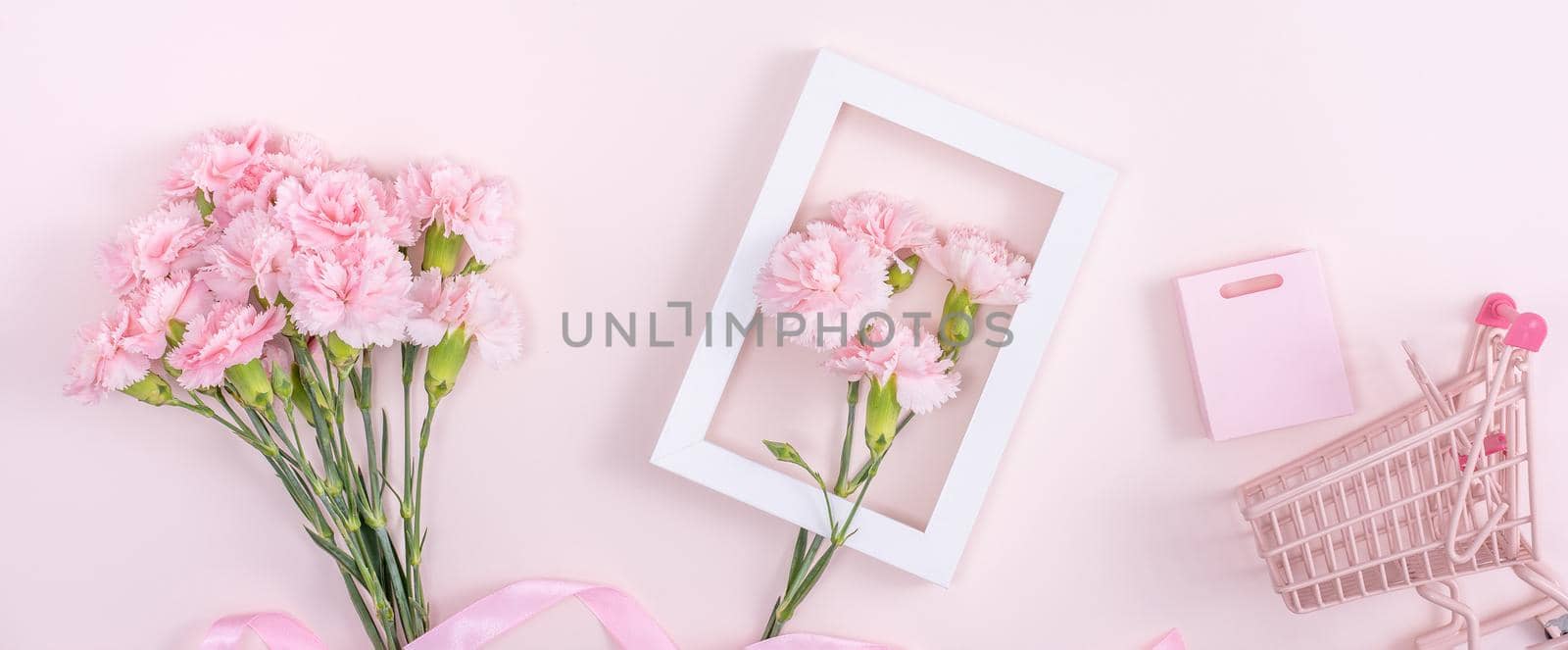 Concept of Mother's day holiday greeting design with carnation bouquet and gift on pink background