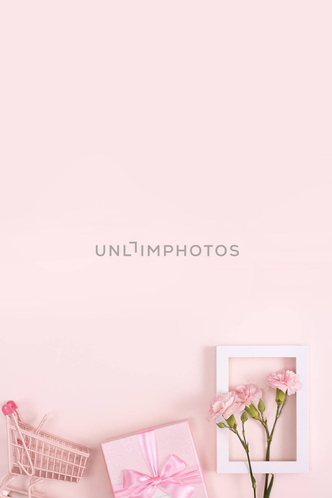Concept of Mother's day holiday greeting design with carnation bouquet and gift on pink background