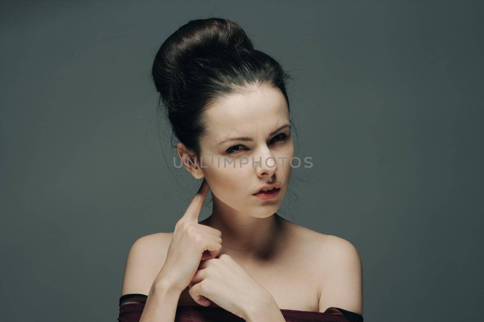 woman with bare shoulders gesturing with hands hairstyle and emotions model. High quality photo