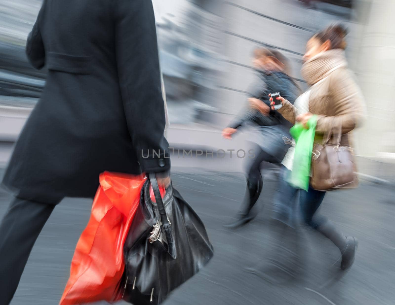 Group of young people hurrying about their business.  Intentional motion blur