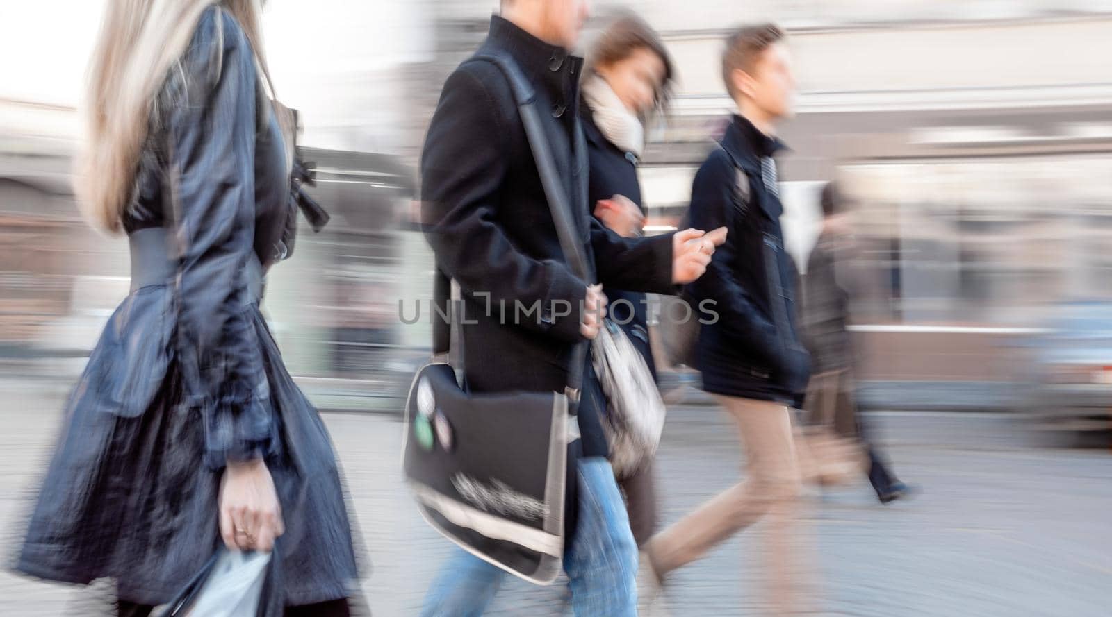 A group of young people going along the street. Intentional motion blur