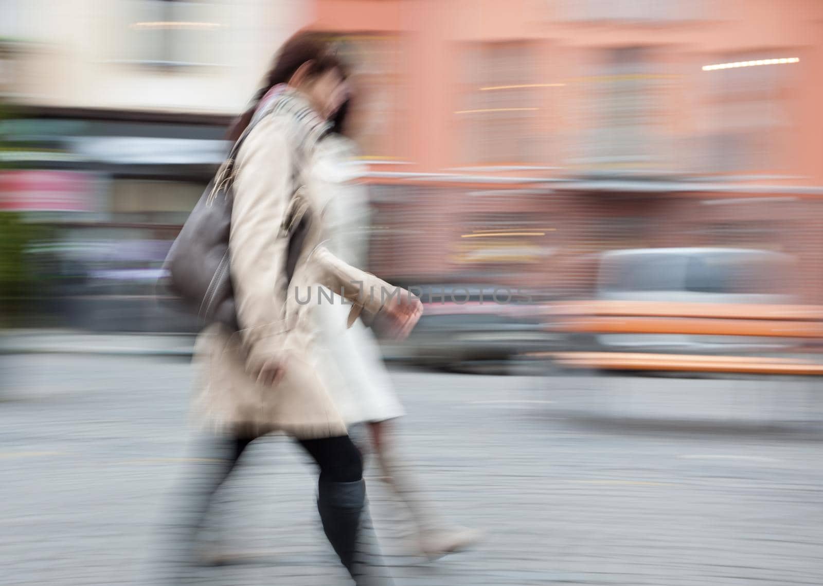 Two young woman at rush hour walking in the street. Intentional motion blur
