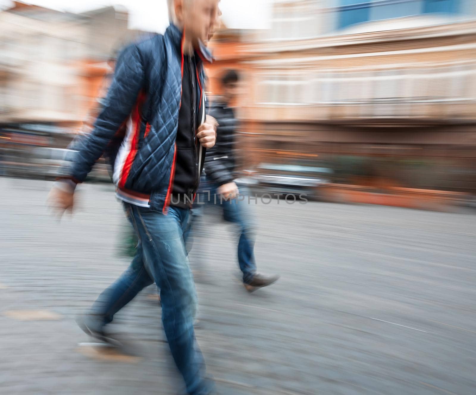 Group of young people hurrying about their business. Intentional motion blur