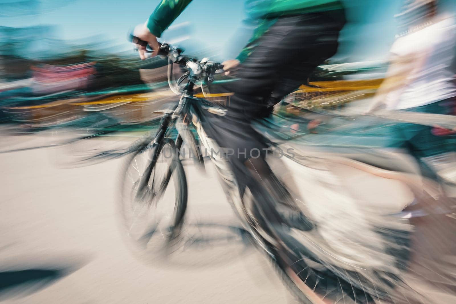 Cyclist on the city roadway in motion blur. Vintage filter with intentional color shift