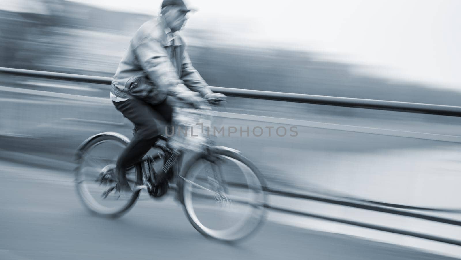 Abstract image of cyclist on the city roadway. Intentional motion blur
