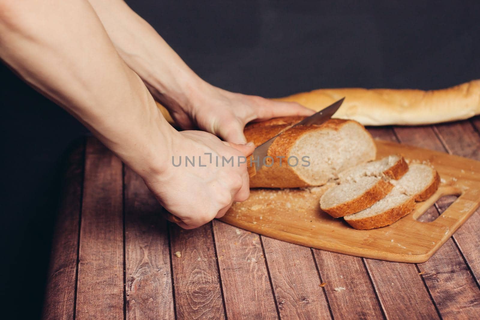 slicing a fresh loaf on a cutting board kitchen meal. High quality photo