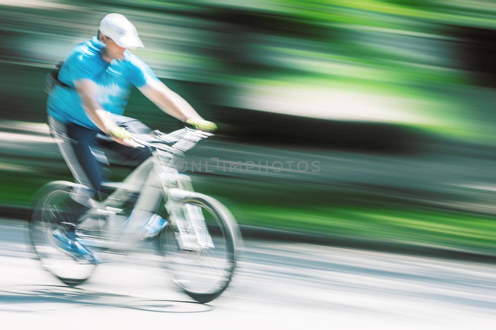 cyclist in traffic on the city roadway. Intentional motion blur
