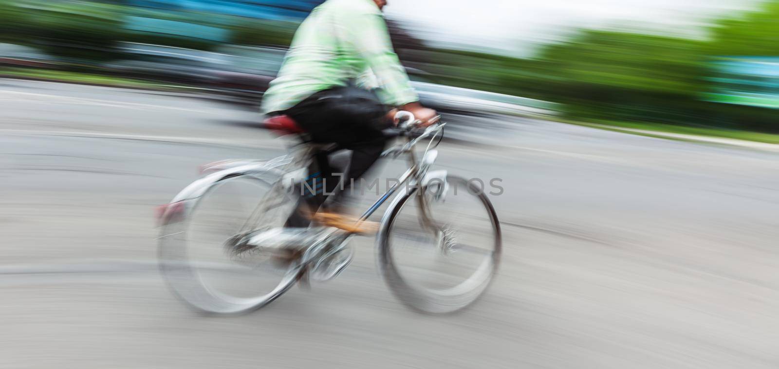 Abstract motion blur image of active people on bicycle in the city roadway
