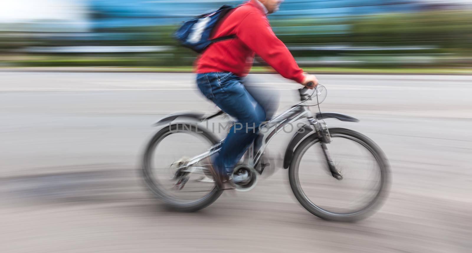 Abstract motion blur image of active people on bicycle in the city roadway