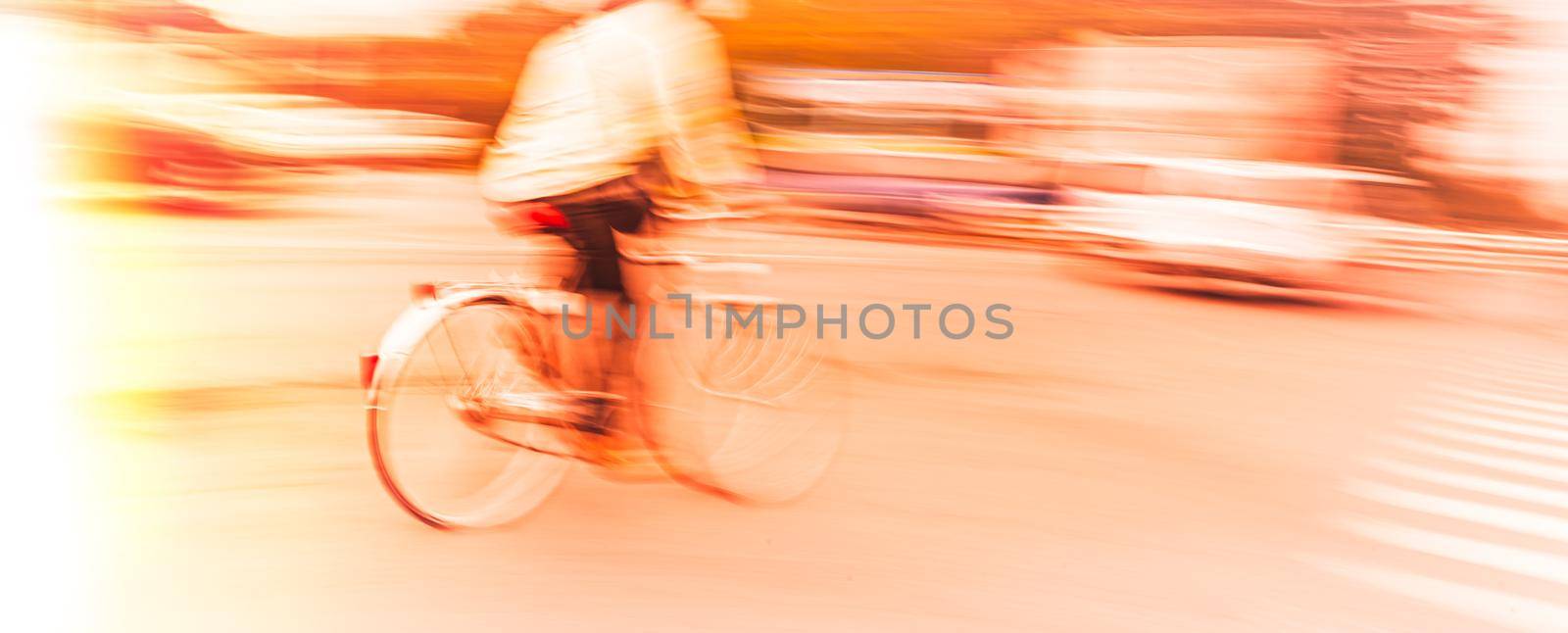 Abstract motion blur image of active people on bicycle in the city roadway