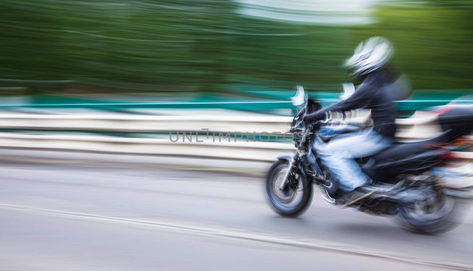Abstract motion blur image of active people on motorcycle in the city roadway