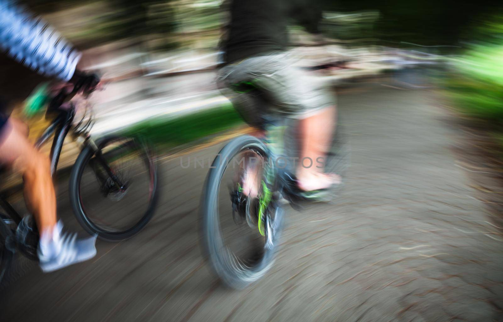 Abstract motion blur image of active people on bicycle in the city roadway