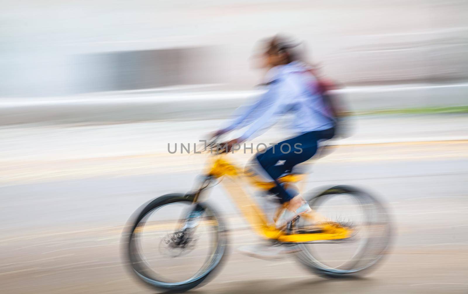Abstract motion blur image of active people on bicycle in the city roadway