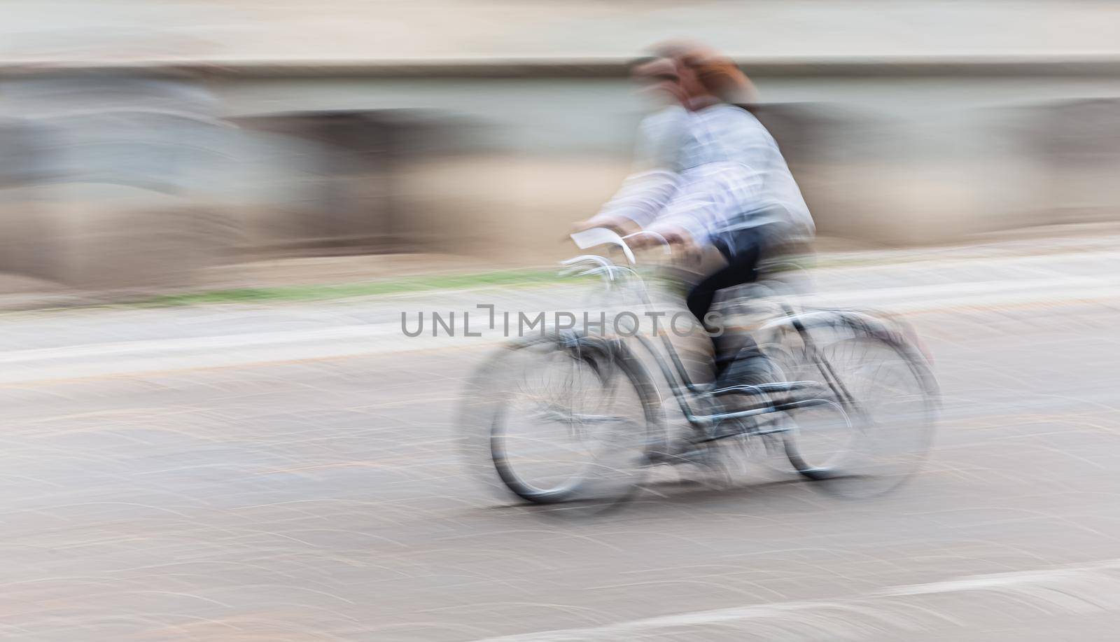 Abstract motion blur image of active people on bicycle in the city roadway
