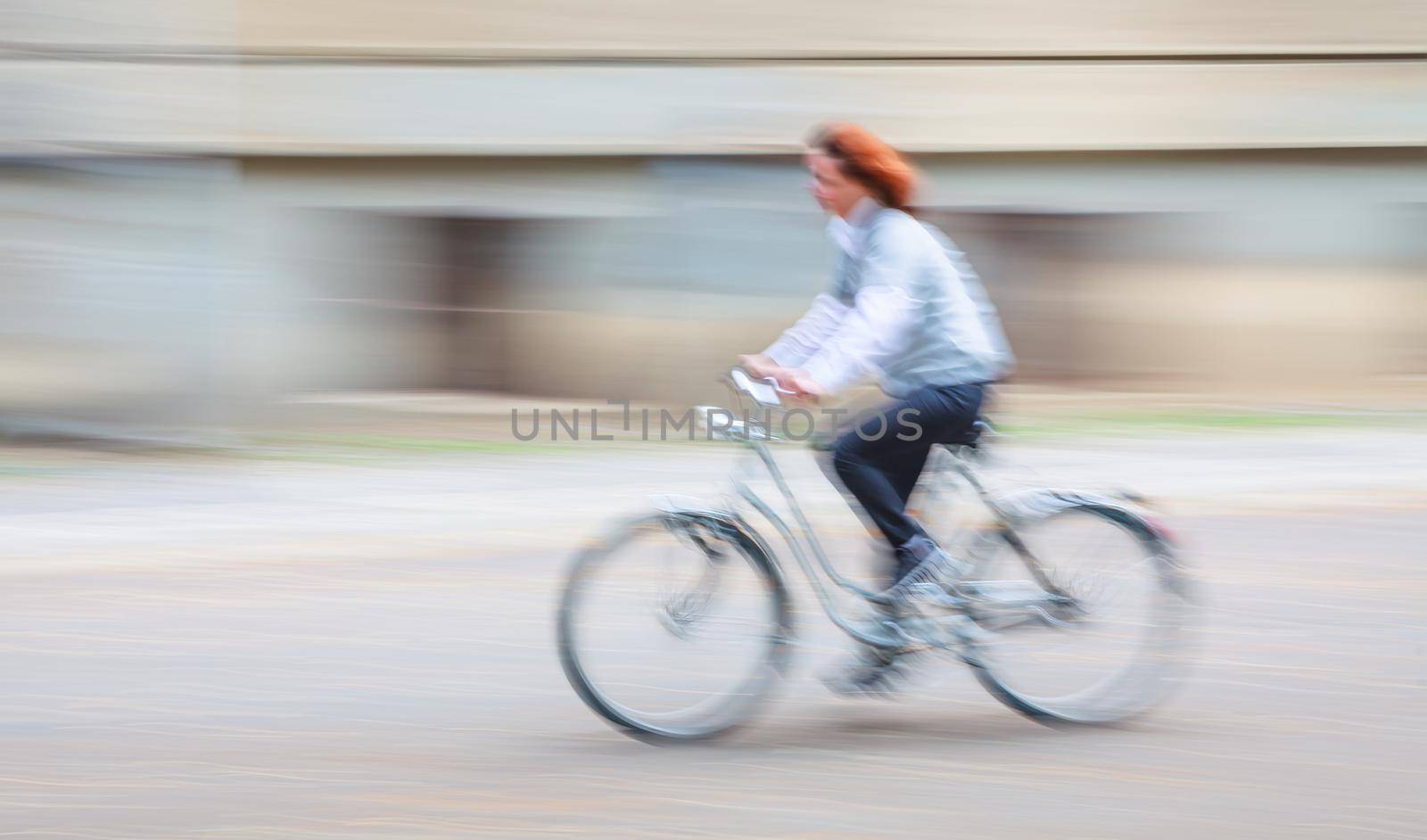 Abstract motion blur image of active people on bicycle in the city roadway