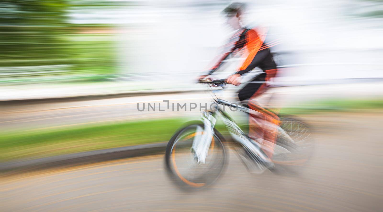 Abstract motion blur image of active people on bicycle in the city roadway