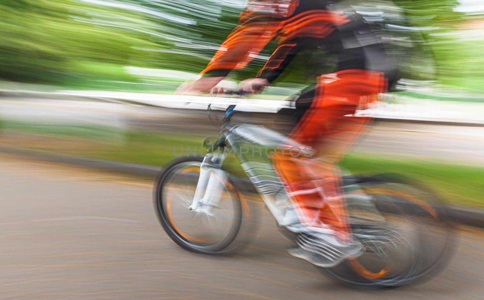 Abstract motion blur image of active people on bicycle in the city roadway