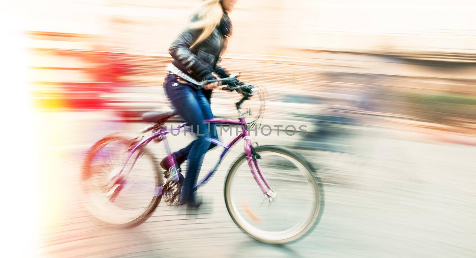 Cyclist on the city roadway in motion blur. Vintage filter with intentional color shift