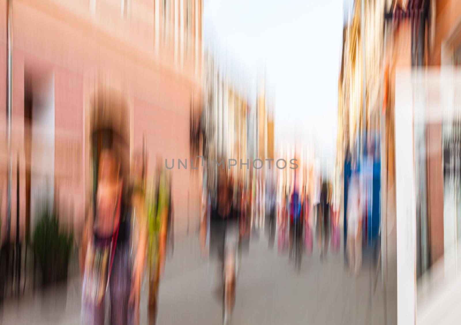 Urban city life background. Motion blur image of crowd of people walking on busy city street