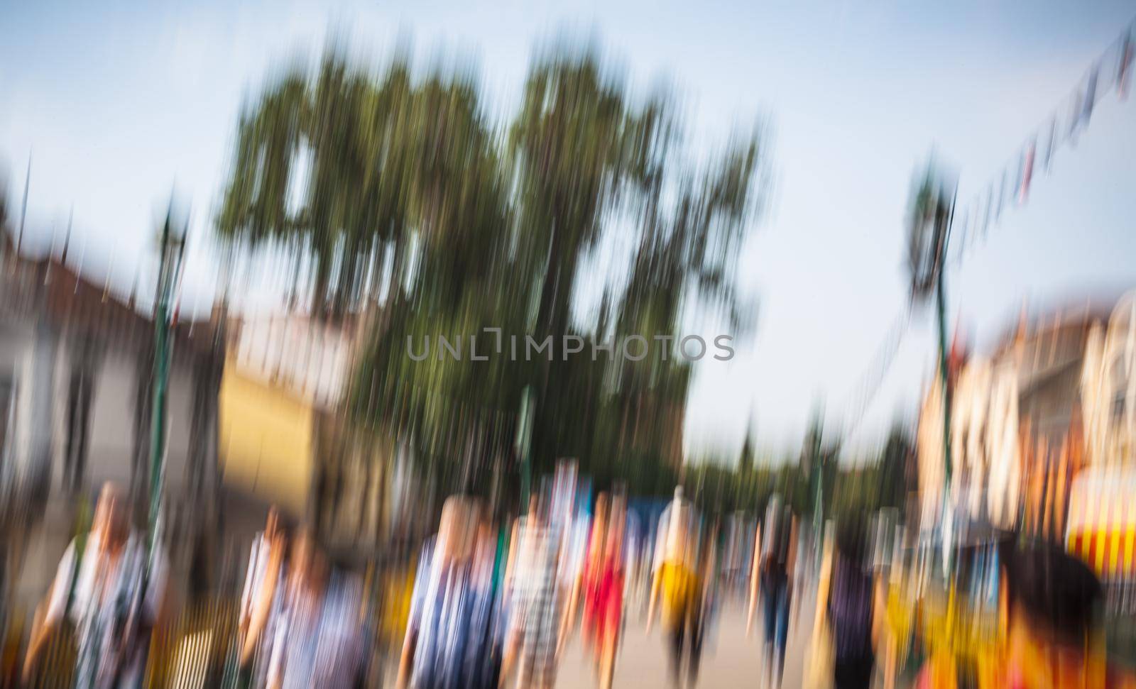Urban city life background. Motion blur image of crowd of people walking on busy city street