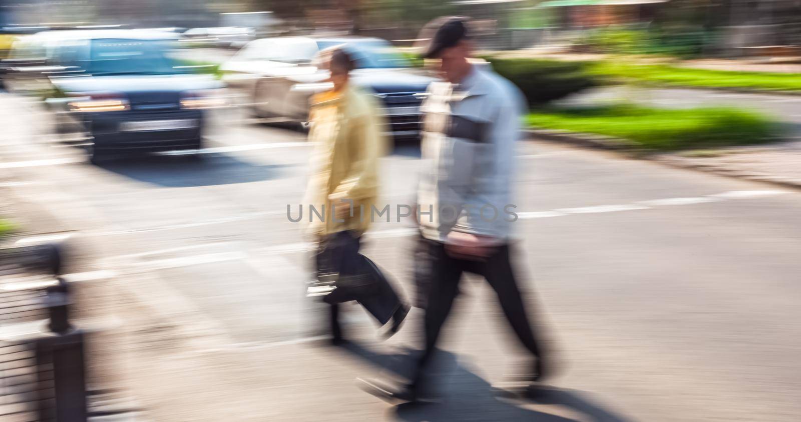City life concept. People rushing in city. Abstract street scene in motion blur. Group of people at a pedestrian crossing