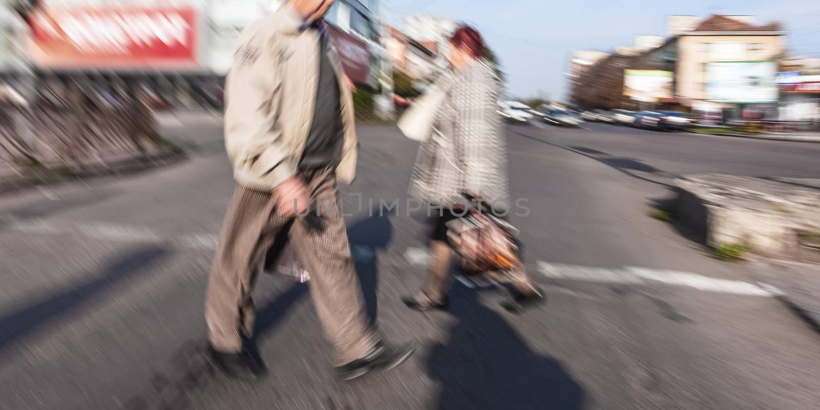 City life concept. People rushing in city. Abstract street scene in motion blur. Group of people at a pedestrian crossing