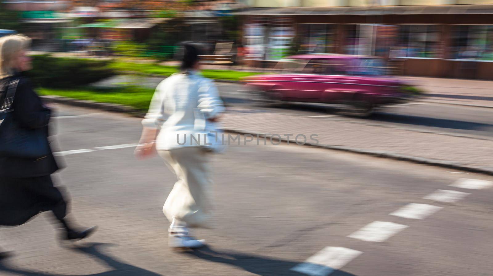 City life concept. People rushing in city. Abstract street scene in motion blur. Group of people at a pedestrian crossing