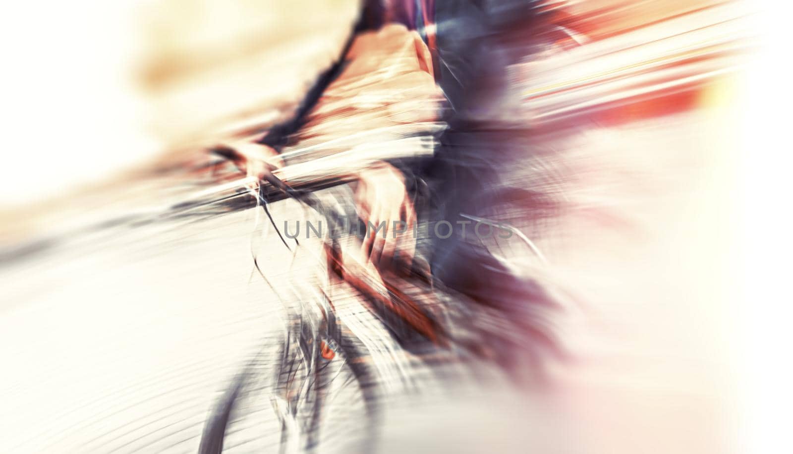 Abstract blurred image of cyclist on the city roadway. Intentional motion blur