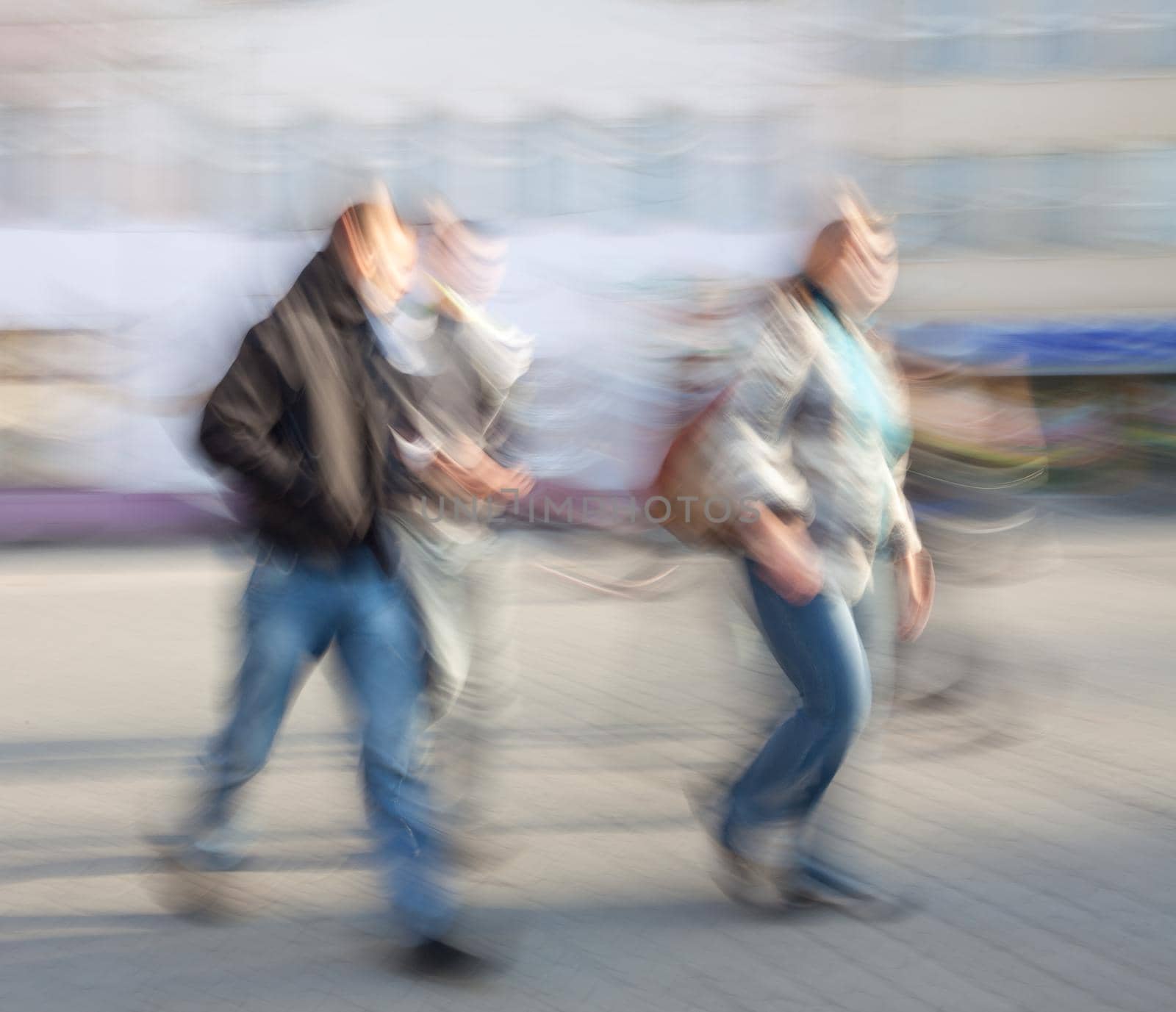 Young people  going about their business. Street scene with intentional motion blur.