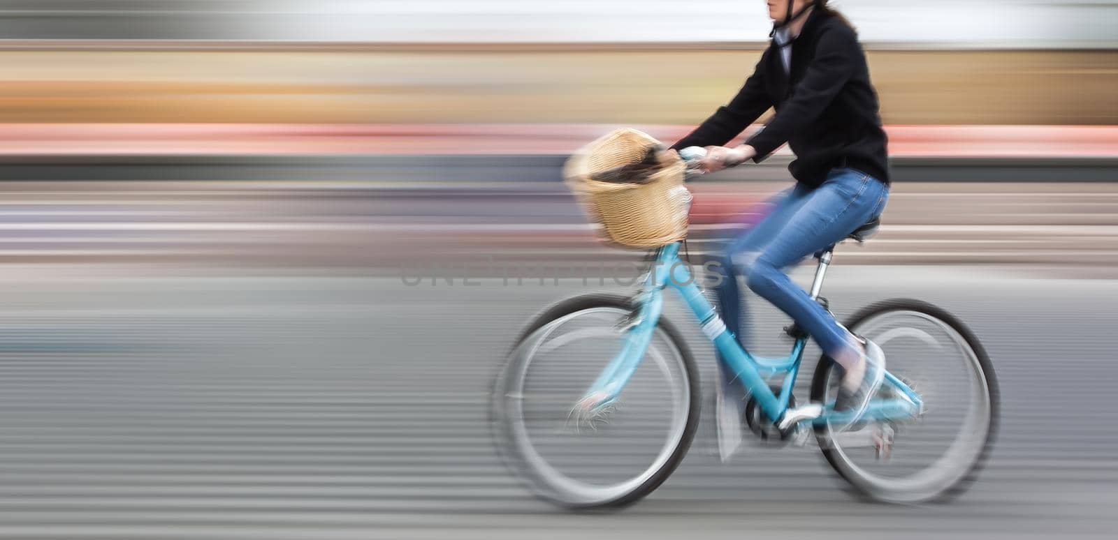 Abstract image of cyclist on the city roadway. Intentional motion blur and color shift