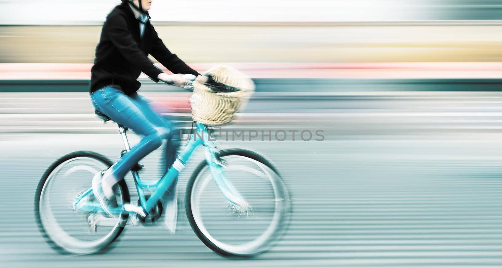 Abstract image of cyclist on the city roadway. Intentional motion blur and color shift