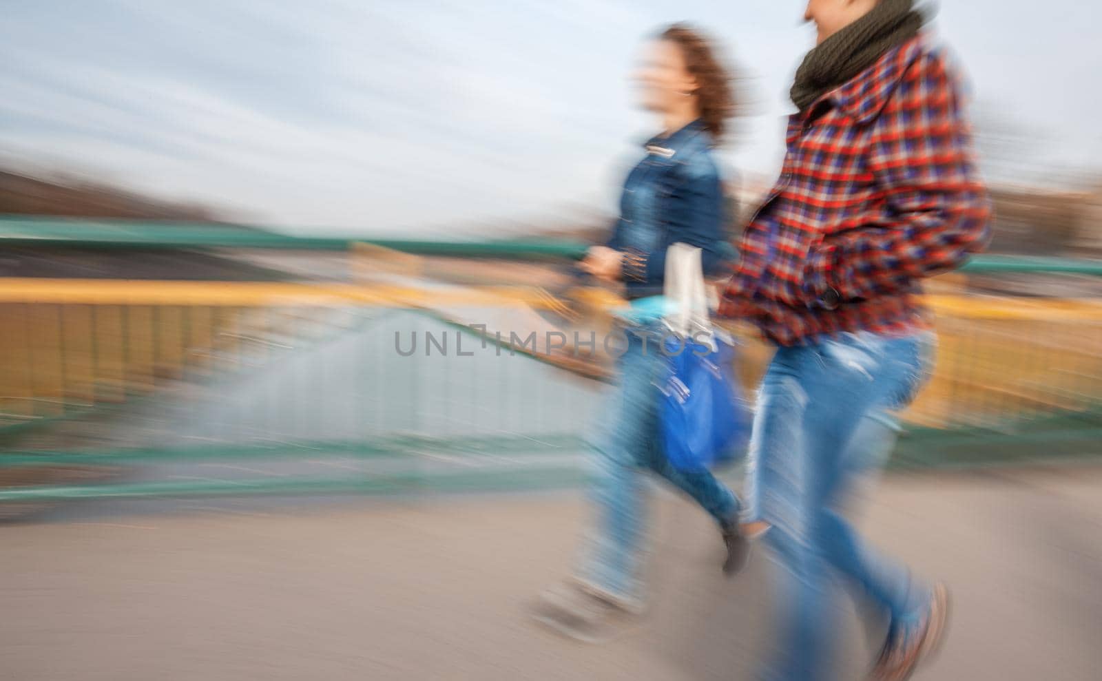 A group of young people going along the street. Intentional motion blur