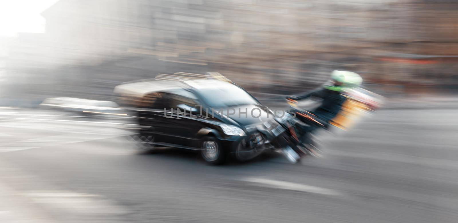 Dangerous city traffic situation with motorcyclist and car in the city in motion blur