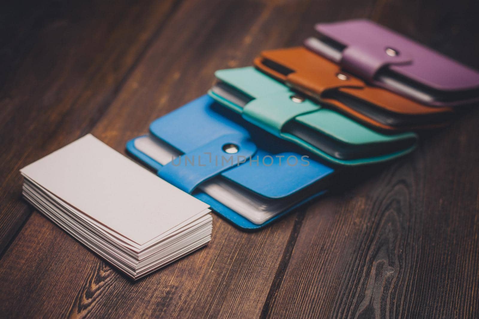 bright business card holders and a pack of white paper on a wooden background close-up by SHOTPRIME