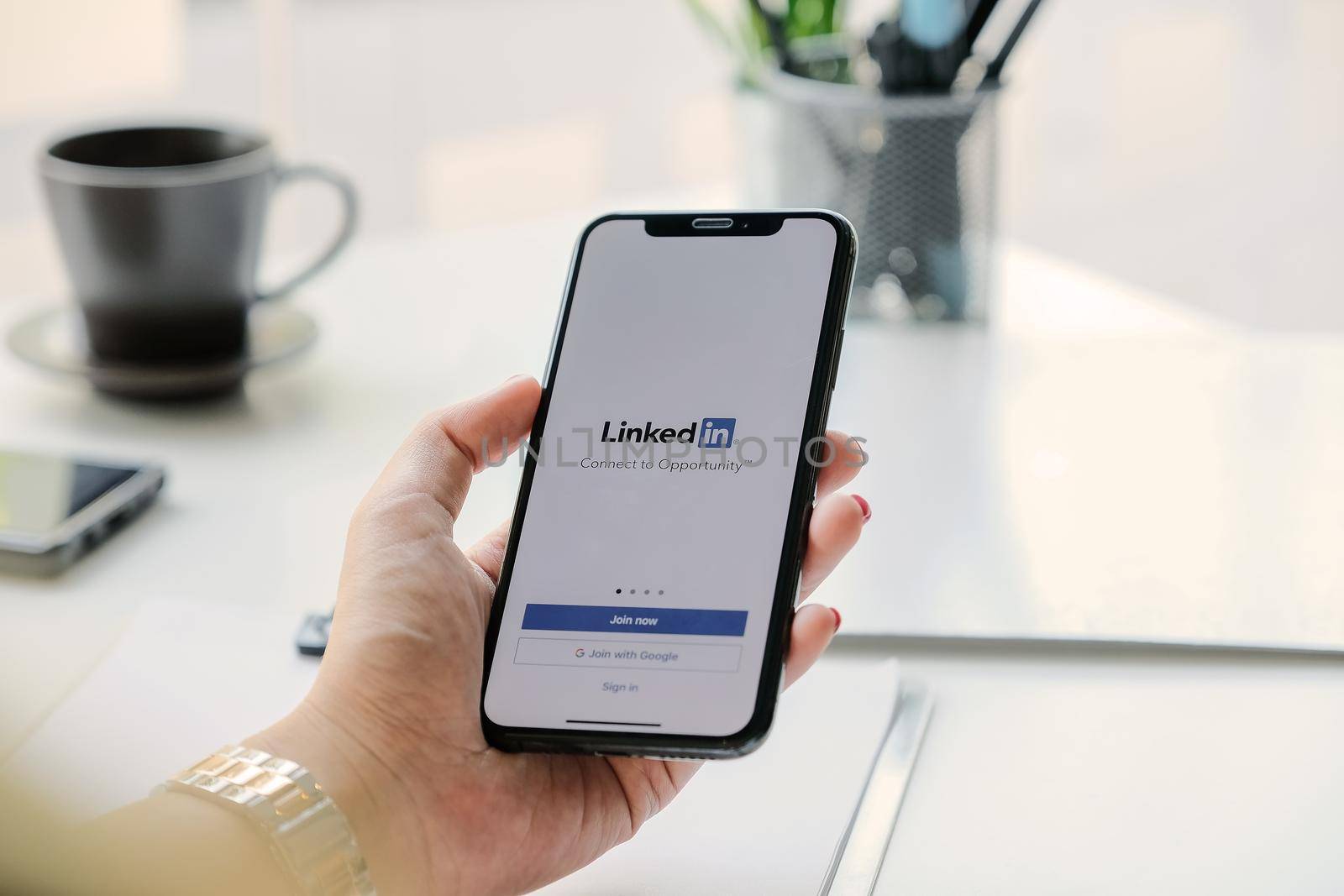 CHIANG MAI, THAILAND, MAR 7, 2020 : A women holds Apple iPhone Xs with LinkedIn application on the screen.LinkedIn is a photo-sharing app for smartphones.