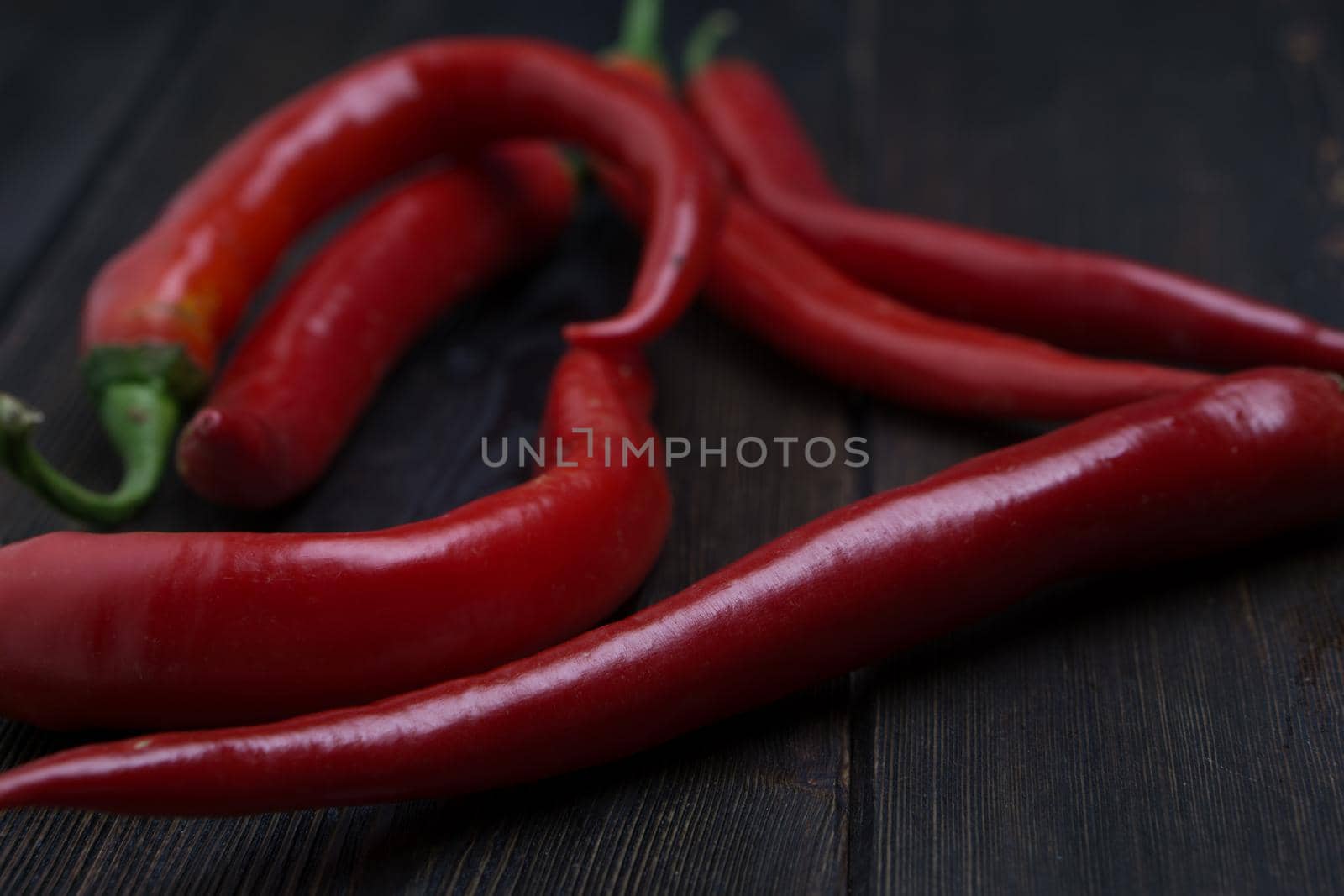 hot chili peppers red wooden table cooking food ingredients. High quality photo