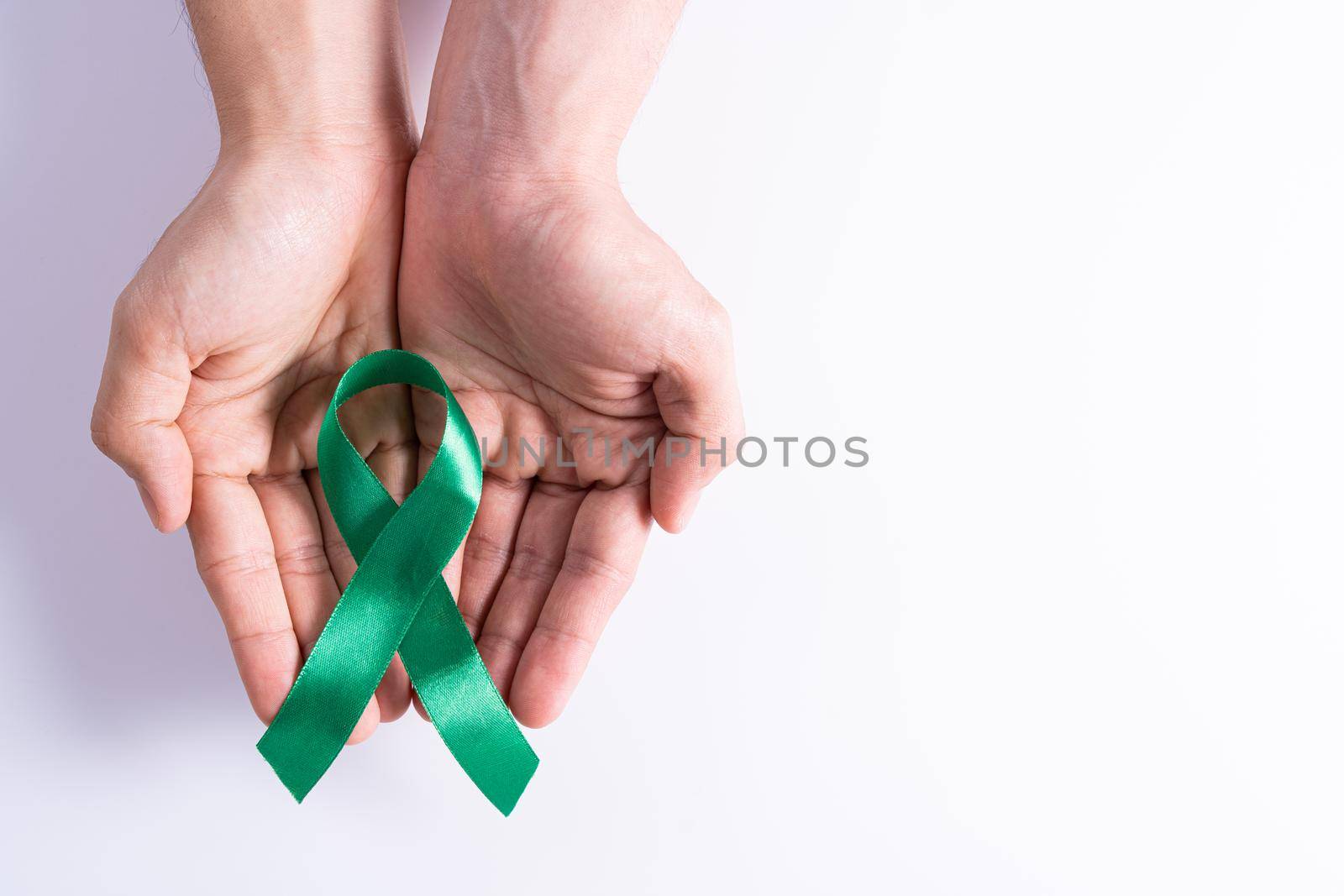 World kidney day, hands holding green ribbon awareness of kidney disease isolated white background. by mikesaran