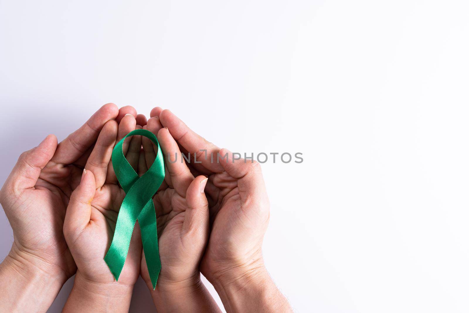 World kidney day, man and woman hands holding green ribbon awareness of kidney disease isolated white background. by mikesaran