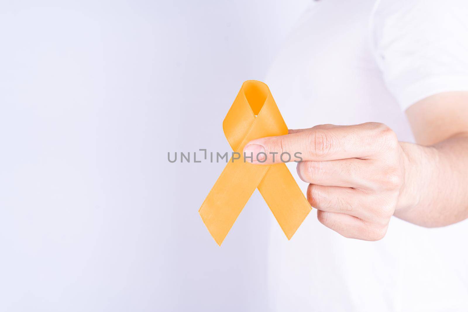 World kidney day, hands holding orange ribbon awareness of kidney disease on chest isolated white background.