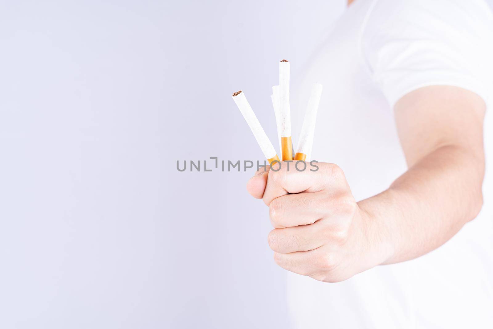 Male hand crushing cigarette. World no Tobacco and stop smoking day.