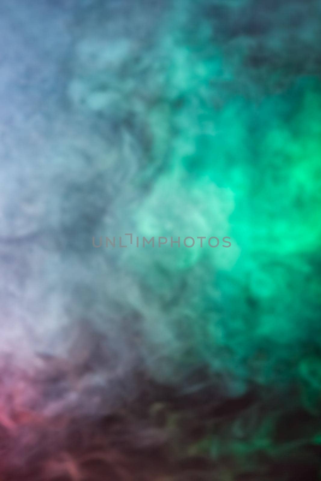 Soft focus abstract image of colorful smoke on dark background. Texture and abstract art