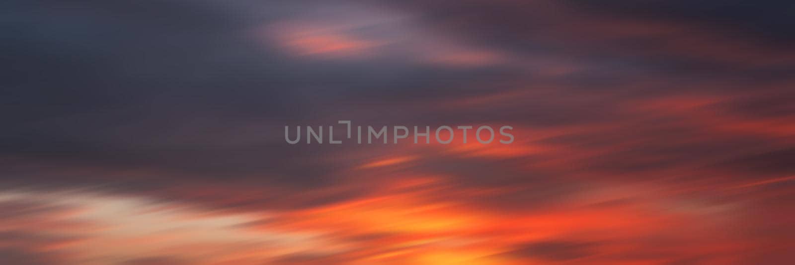 Blurred nature background. Smooth relax landscape. Abstract sunset sky with motion blurred clouds