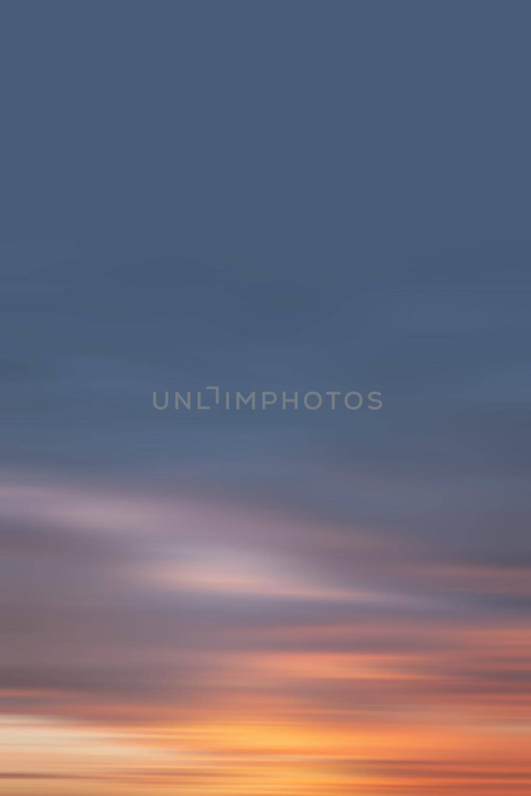 Blurred nature background. Smooth relax landscape. Abstract sunset sky with motion blurred clouds