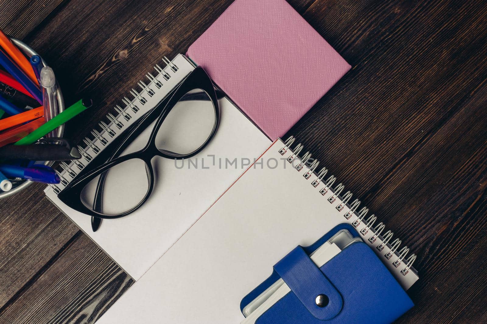 white paper on the table notepad card holder glasses and stationery. High quality photo