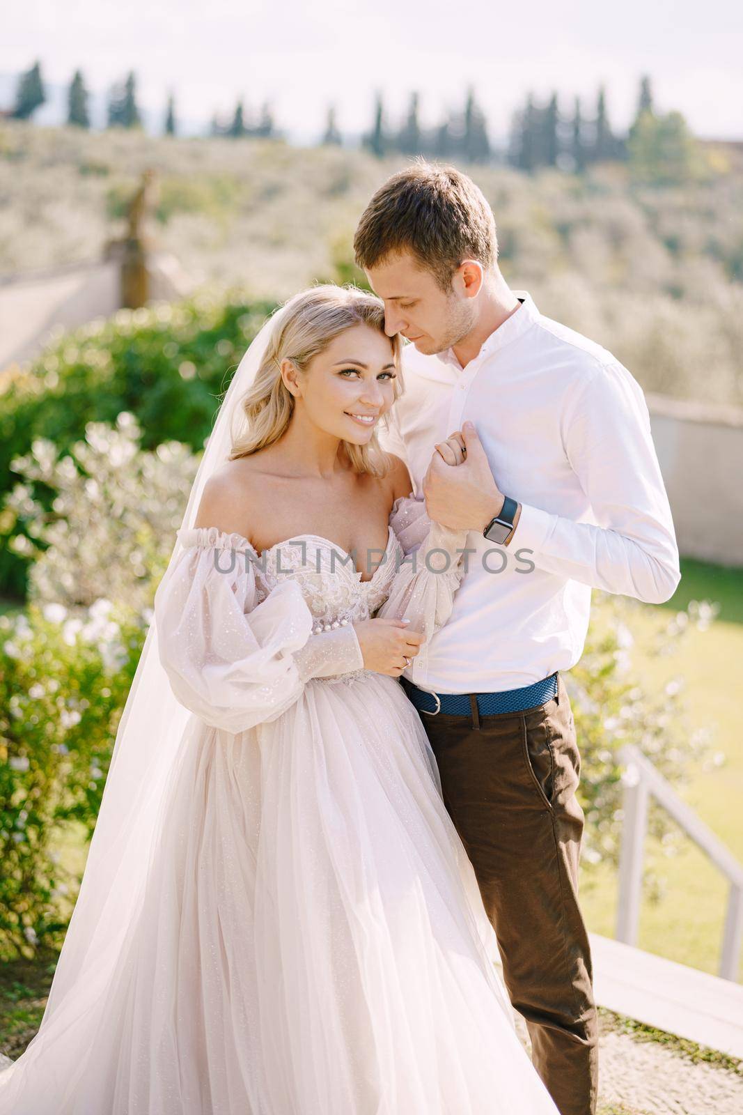 Wedding couple in the garden at sunset. Wedding in Florence, Italy, in an old villa-winery.