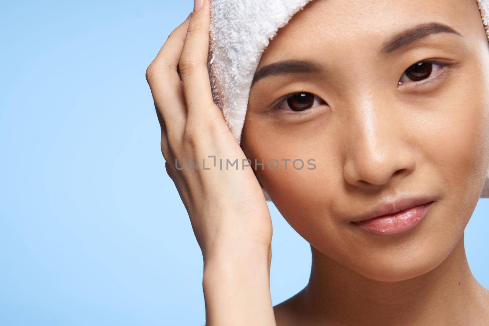 woman with bare shoulders close-up towel on head clean skin rejuvenation. High quality photo
