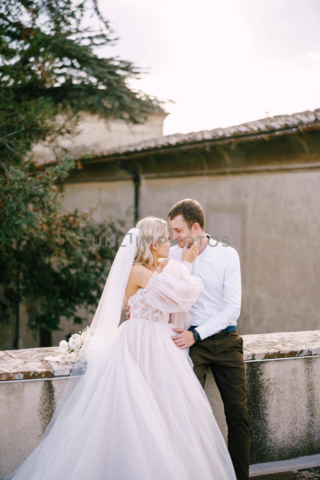 Wedding couple on the roof of an old winery villa. Wedding at an old winery villa in Tuscany, Italy.