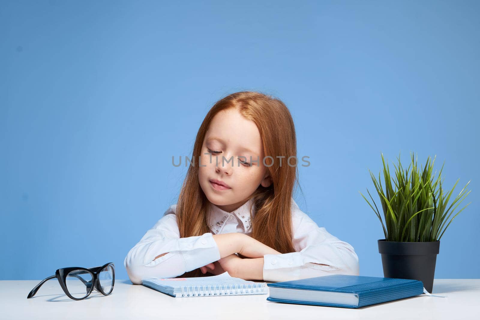 schoolgirl doing homework at the table education lifestyle. High quality photo