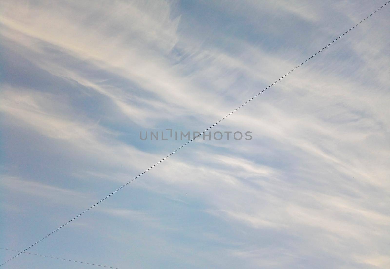 Blue sky with clouds and electric wire.